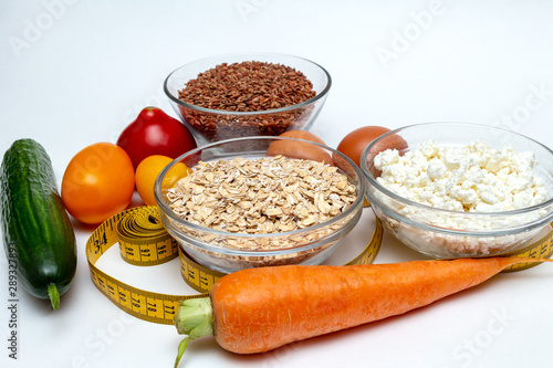 buckwheat, cereals, measuring tape, farm cottage cheese, carrot, egg, tomatoes, cucumber close up on white background protein healthy diet fat free concept eco product sports nutrition