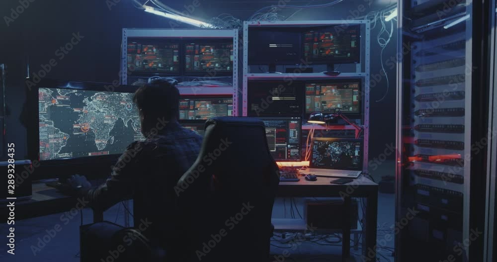 Hacker watching multiple monitors Hacker watching multiple monitors