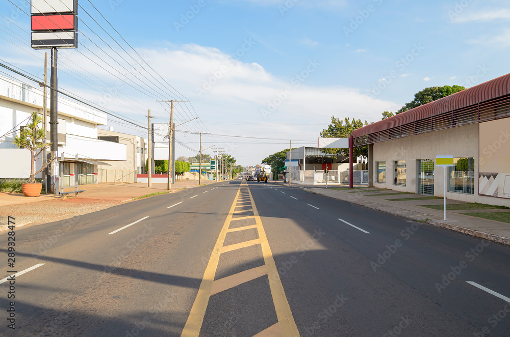 Large avenue with four lanes, few cars on the street. Ceara avenue at Campo Grande MS, Brazil.
