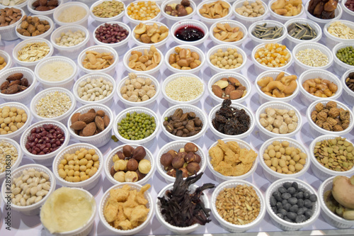Fototapeta Naklejka Na Ścianę i Meble -  Cereal grains, seeds, beans on white plastic plate.