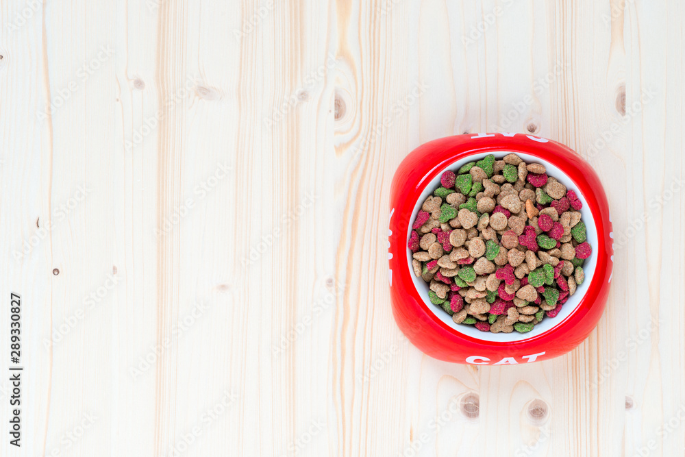 top view of a bowl of dry cat food, space left top view of a bowl of dry cat food, space left