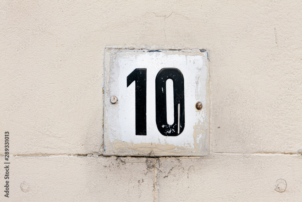 Street number sign on the wall