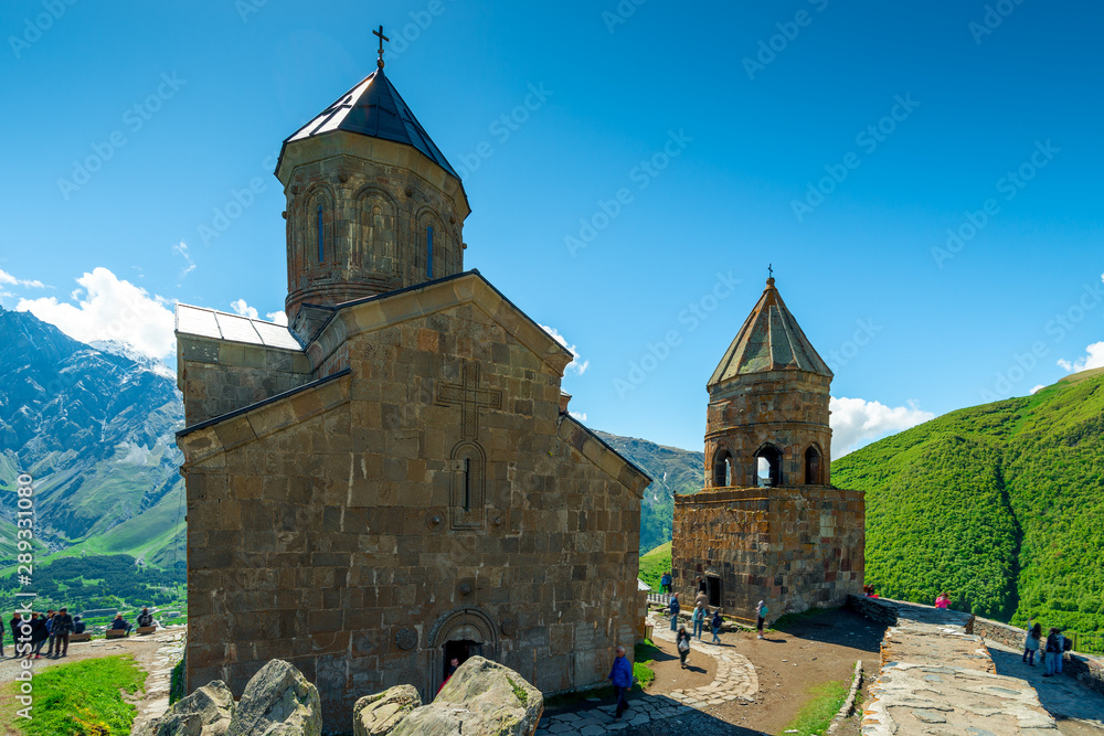 Beautiful Trinity Church above the village of Gergeti in Georgia on the mountain