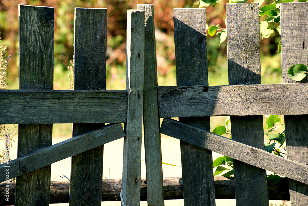 Old wooden fence on a summer day Old wooden fence on a summer day