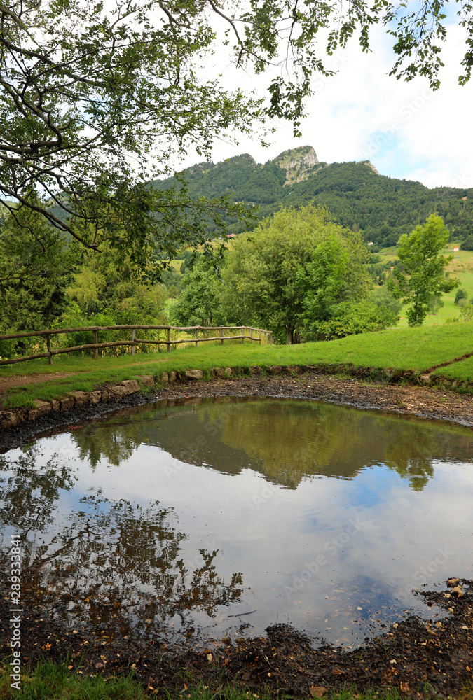 small pond and the reflection of mountains on the water small pond and the reflection of mountains on the water