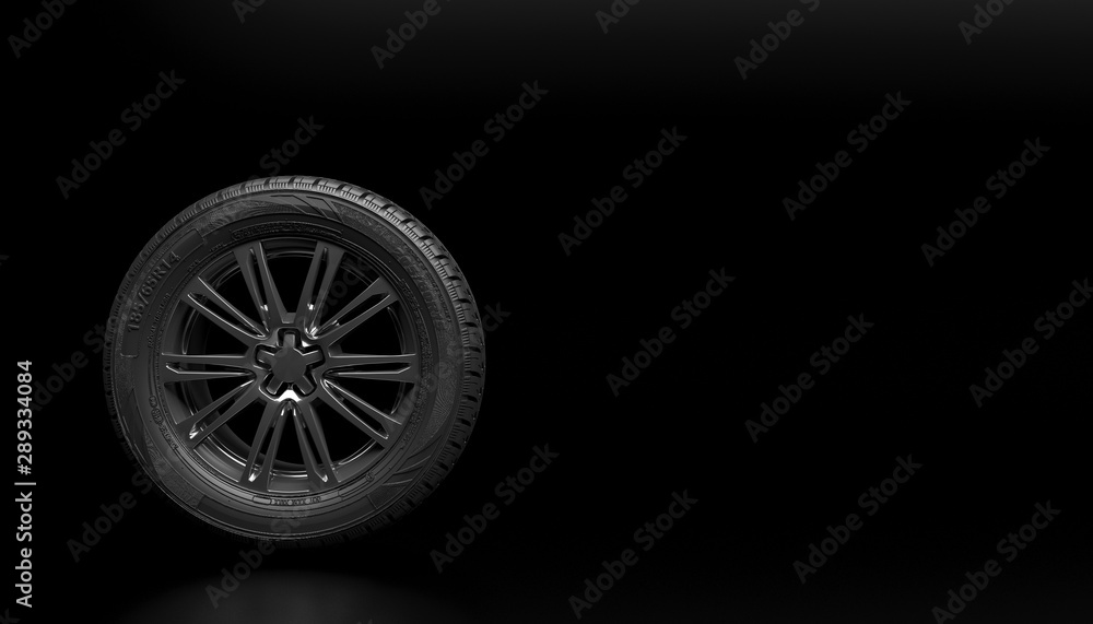 Single new car wheel isolated on a black background. Mock up for advertising car service or auto maintenance. Copy space for text or logo. 3D rendering.