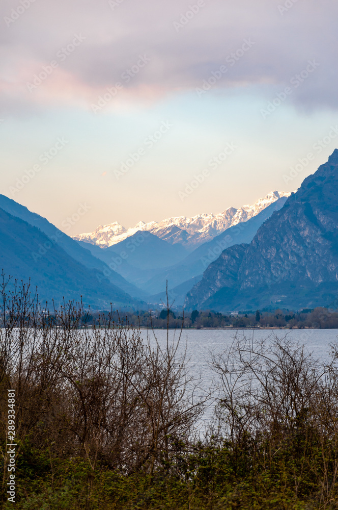 Panorama of Lake Idro from the town of Anfo, with a tourist and fishing port, a tourist destination for holidays at the lake, at the foot of the Alps immersed in unspoilt nature.