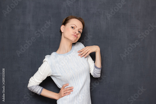 Studio shot of funny woman imitating sexy photo pose