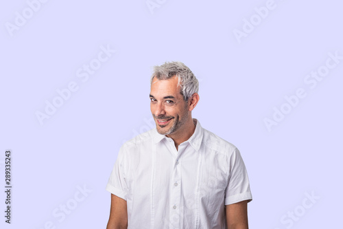 Concept of human facial expressions. A Hispanic man with an attractive, true, daring, mischievous look.on a background-colored wall.