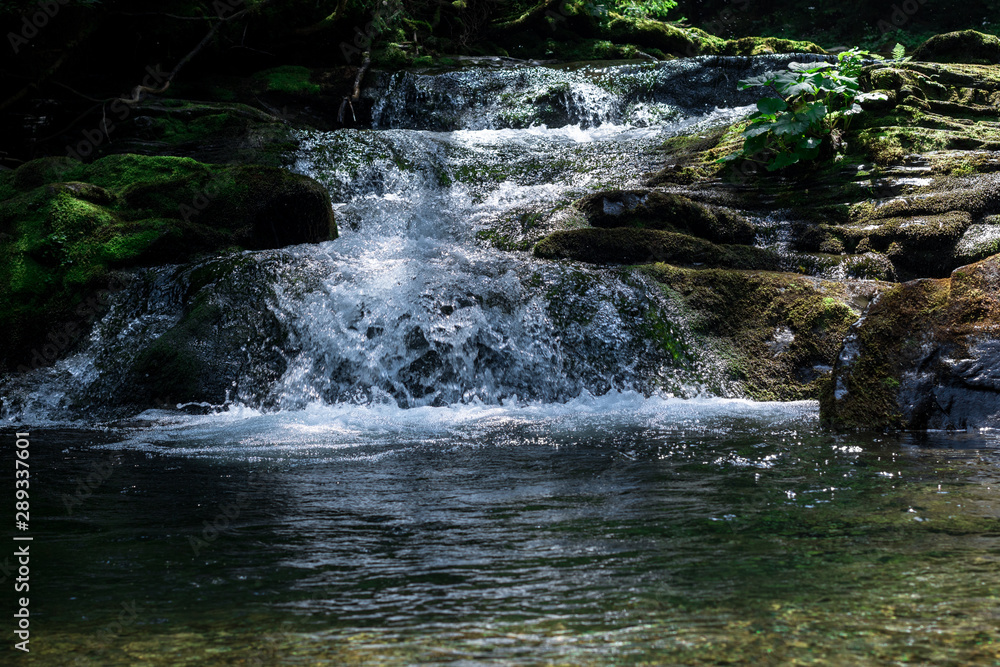 small mountain waterfall with clear water which flowing in the pond small mountain waterfall with clear water which flowing in the pond