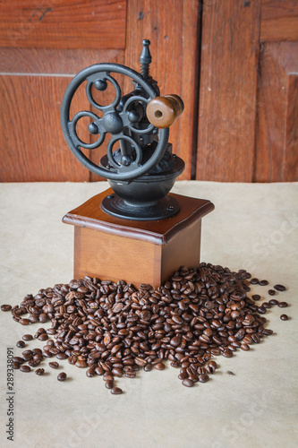 Manual coffee grinder with  black coffee beans