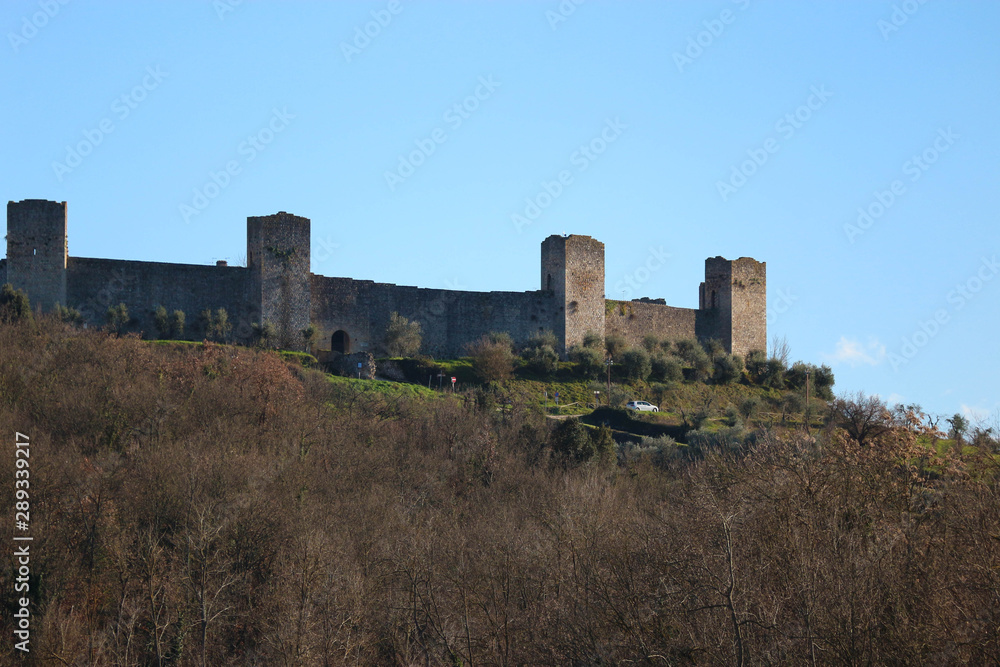 Scenic view of wall and towers of medieval town Monteriggioni on the hill, Tuscany, Italy