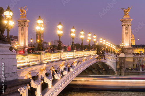 Panoramic view of the Pont Alexandre III bridge illuminated in evening with the Seine River. 8th Arrondissement, Paris, France
