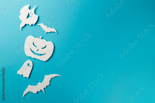Halloween decorations. Halloween paper decorations on pastel blue background. Top view. Flat lay of accessory decoration Halloween festival. Copy space. Minimal creative concept. Pastel colors