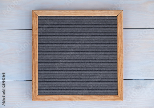 empty grey felt letterboard on natural wood background. procurement for design