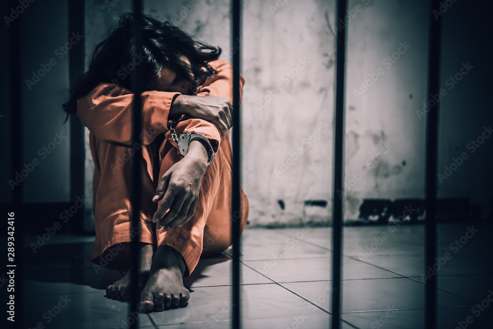 Portrait of women desperate to catch the iron prison,prisoner concept,thailand people,Hope to be free,If the violate the law would be arrested and jailed. Portrait of women desperate to catch the iron prison,prisoner concept,thailand people,Hope to be free,If the violate the law would be arrested and jailed.
