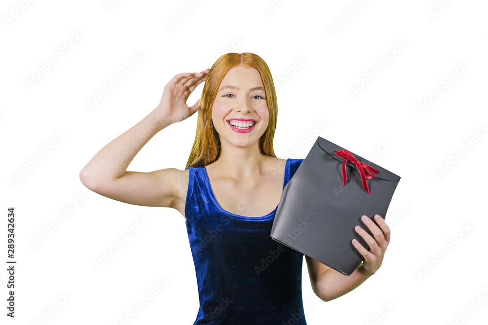 beautiful girl standing on a red background with a gift in the hands smiles a lovely smile. celebration of Christmas in the office,or new year beautiful girl standing on a red background with a gift in the hands smiles a lovely smile. celebration of Christmas in the office,or new year
