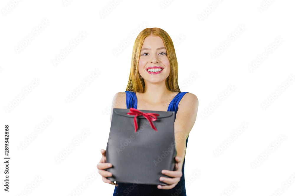 beautiful girl standing on a red background with a gift in the hands smiles a lovely smile. celebration of Christmas in the office,or new year beautiful girl standing on a red background with a gift in the hands smiles a lovely smile. celebration of Christmas in the office,or new year