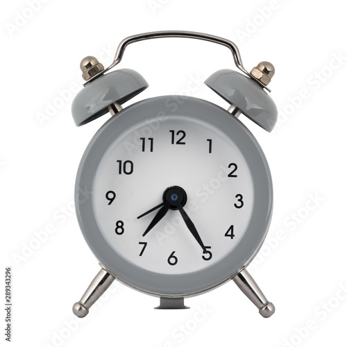 A gray clock with an alarm clock on a white background with arrows showing the time seven hours twenty five minutes or nineteen hours twenty five minutes