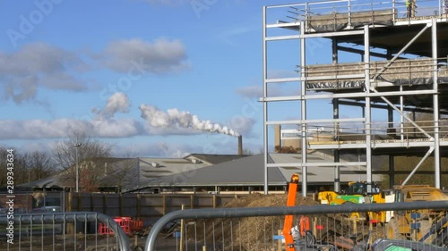 Smoke Pollution Pouring Out Over Clear Blue Sunny Sky, Green House Gas Emmisions photo