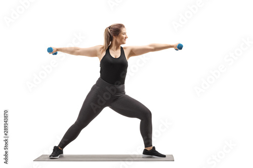 Strong woman exercising with dumbbells