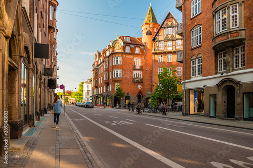 Street life in Copenhagen. People walking, riding bikes in the city center