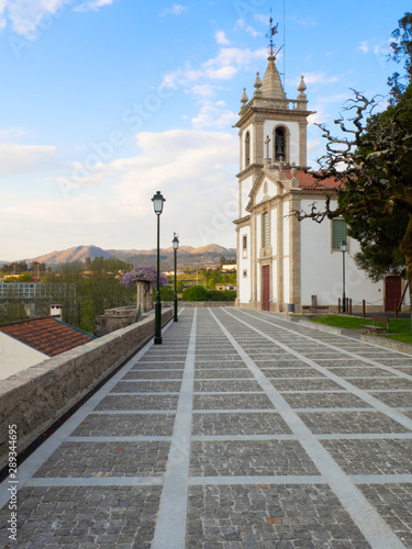 Arcos de Valdevez, Portugal - March 30, 2019: The Espirito Santo Church and the mountain landscape of the city in the background. The view is from Jardim dos Centenários, in the city center.