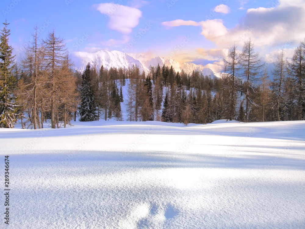 Scenic mountain winter landscape with footprints covered with fresh snow