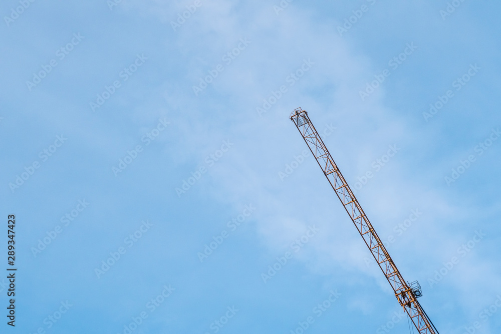Background with crane arm against blue sky. Copy space fot text. Background with crane arm against blue sky. Copy space fot text.