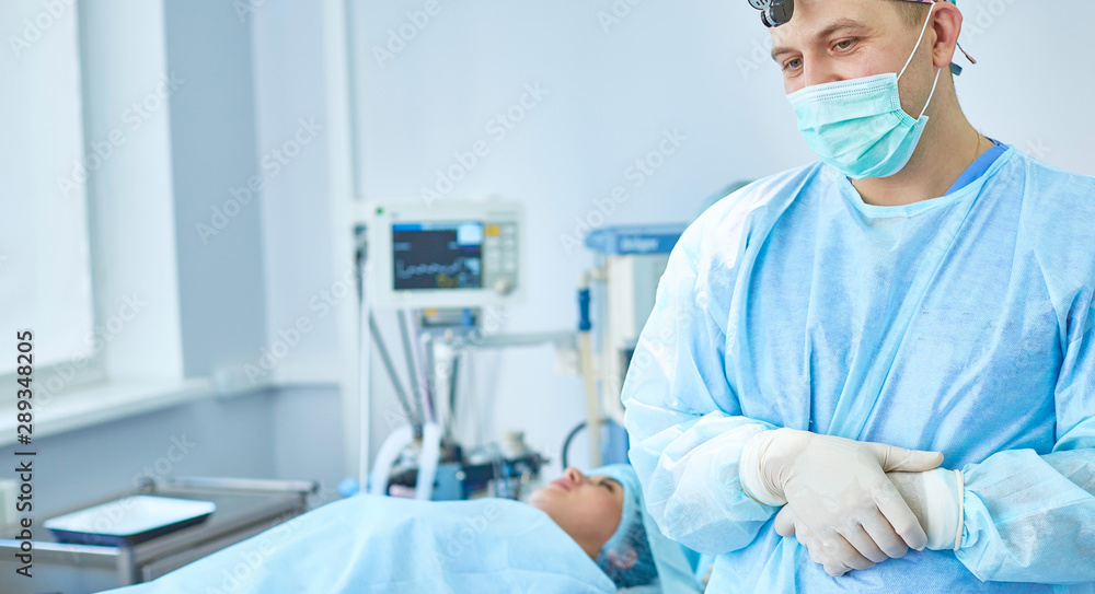 Several doctors surrounding patient on operation table during t Several doctors surrounding patient on operation table during t