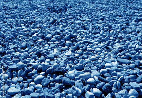 Pile of small gravel stones in navy blue tone.