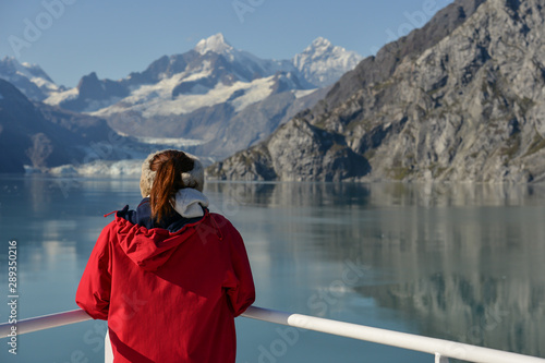 Young woman looks out at Glacier on a summers day. © dabyg
