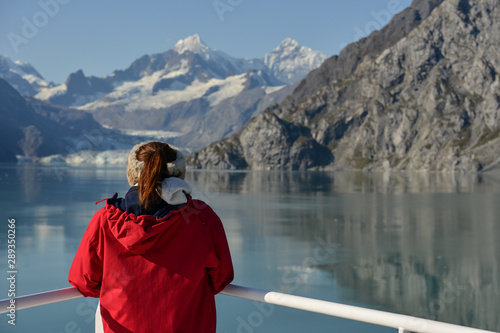 The wonders of nature, a young woman looks out at a Glacier in the distance.  © dabyg