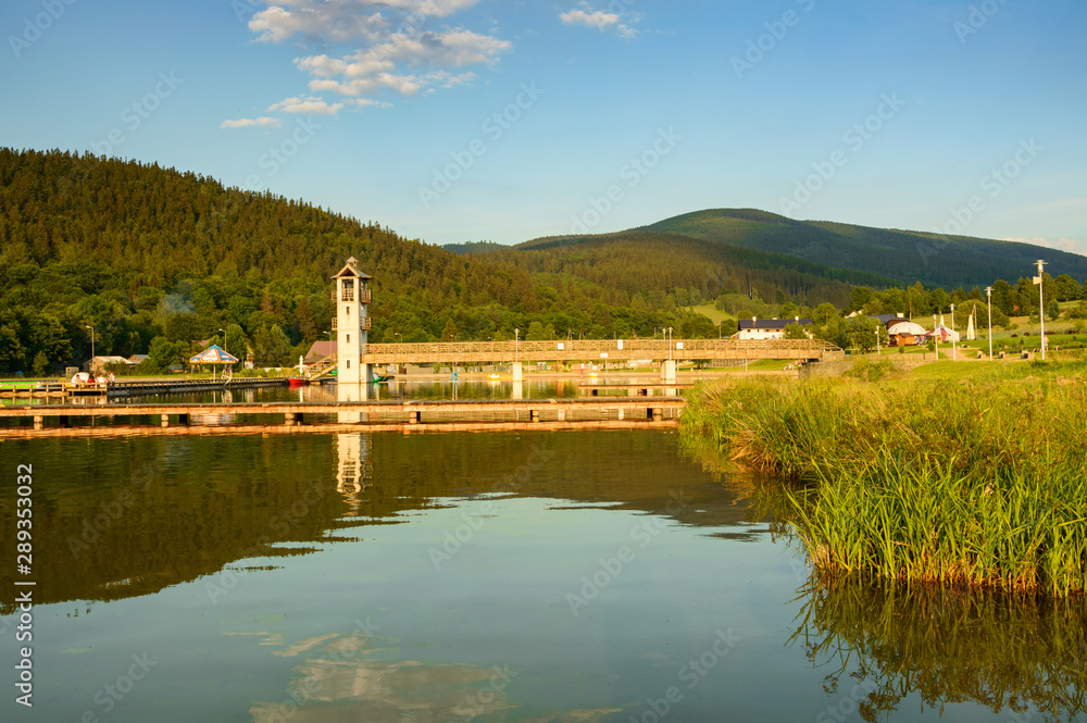Lake in the mountain valley, swimming pool with a lookout tower.