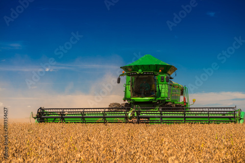 Harvester harvesting soybeans with blue sky in Brazil