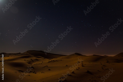Night landscape. Dunes in the Sahara Desert by Moonlight