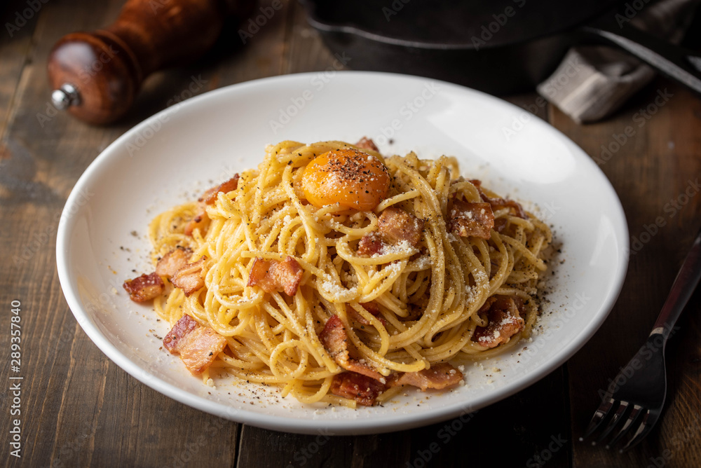 carbonara spaghetti with raw egg yolk on top carbonara spaghetti with raw egg yolk on top