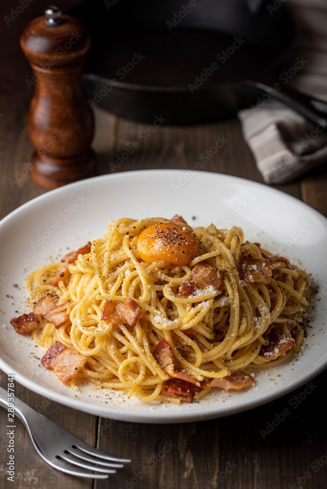 carbonara spaghetti with raw egg yolk on top