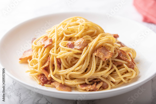 carbonara spaghetti with raw egg yolk on top