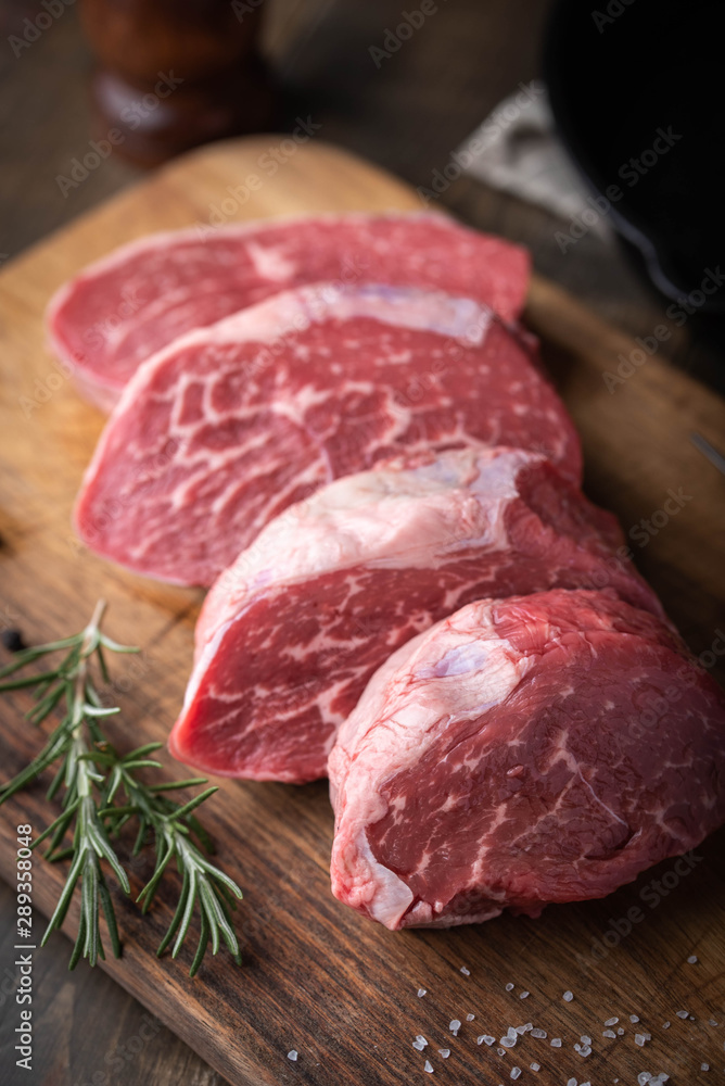 raw beef tenderloin on wooden cutting board raw beef tenderloin on wooden cutting board