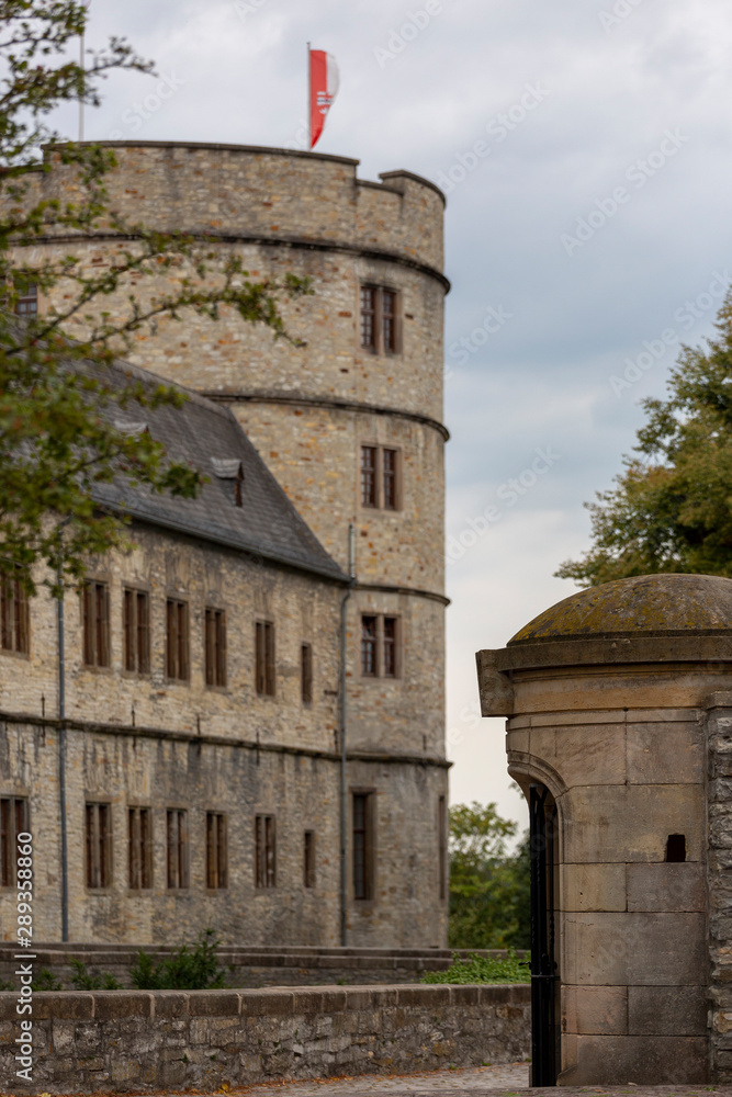 Entrance and main portal into the Wewelburg castle with the large round tower in the background