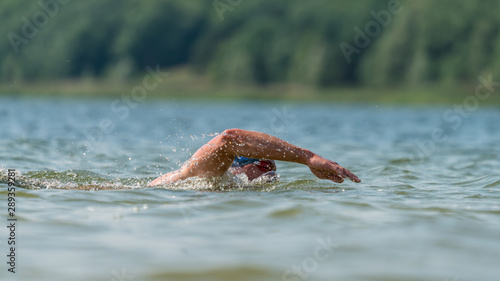 Triathlete swimming in a lake
