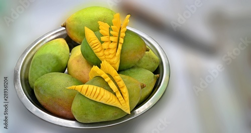 Mangoes on Steel Plate with Beautifully Cut Pieces on top