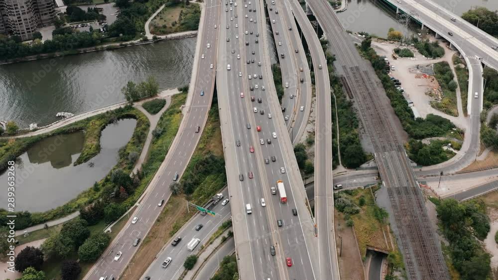 Aerial establishing shot of highway traffic on an overcast day. Cinematic 4K footage. Aerial establishing shot of highway traffic on an overcast day. Cinematic 4K footage.