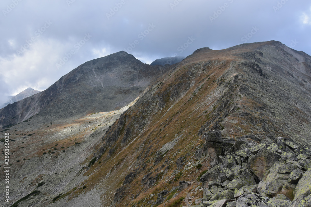 Irechek Peak, Rila Mountain, Bulgaria in cloudy autumn day, Musala peak seen at distance Irechek Peak, Rila Mountain, Bulgaria in cloudy autumn day, Musala peak seen at distance