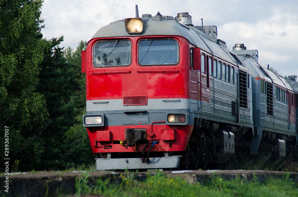 Red-gray passenger long-distance train close-up. Russian Railways. Red-gray passenger long-distance train close-up. Russian Railways.