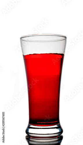 Red water with glass on white background