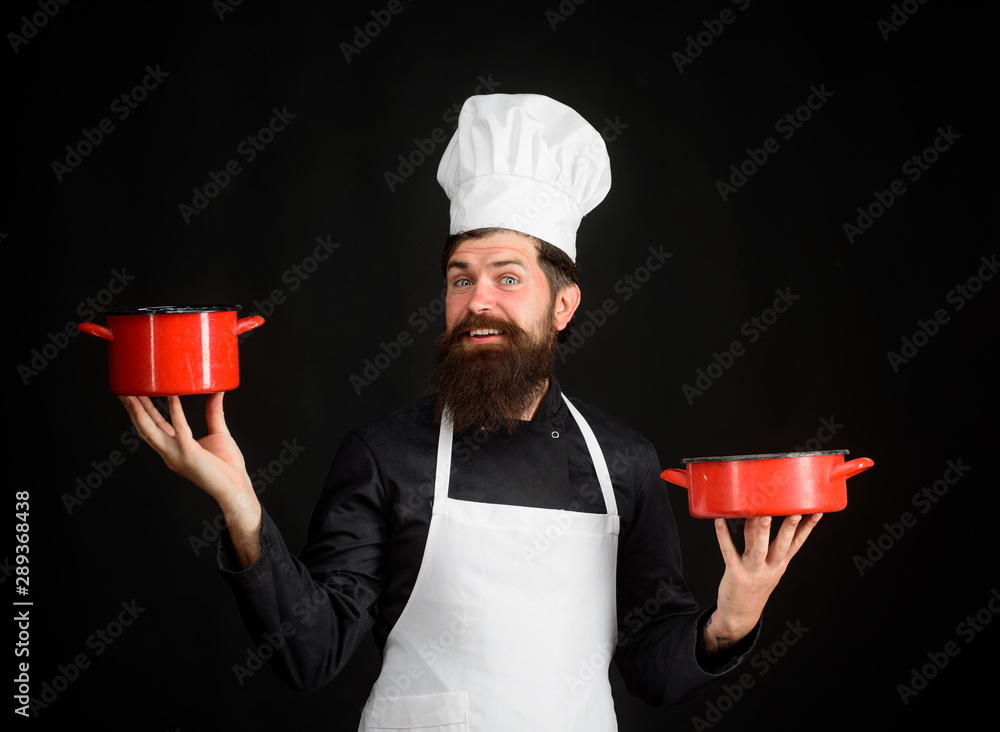 Bearded man cook wear chef hat and uniform. Male chef, cook, baker in  uniform holds saucepan