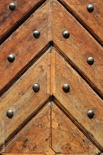 Fragment of old wooden doors with metal rivets