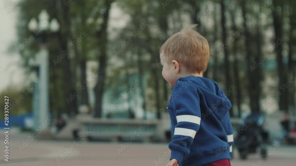 Boy with mom play catch-up in the park. Parental care, parental love Boy with mom play catch-up in the park. Parental care, parental love